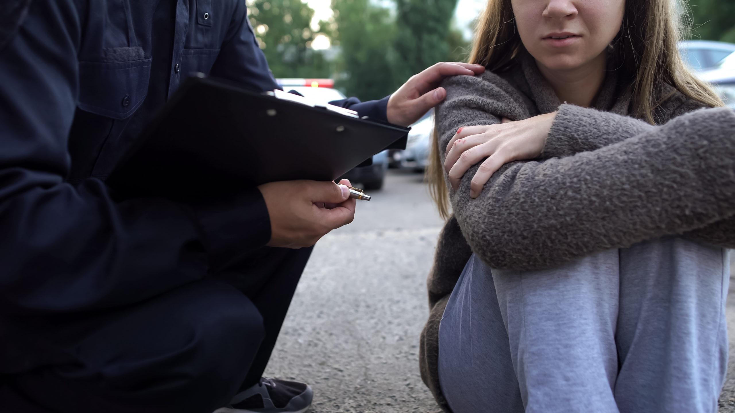 officer helping woman