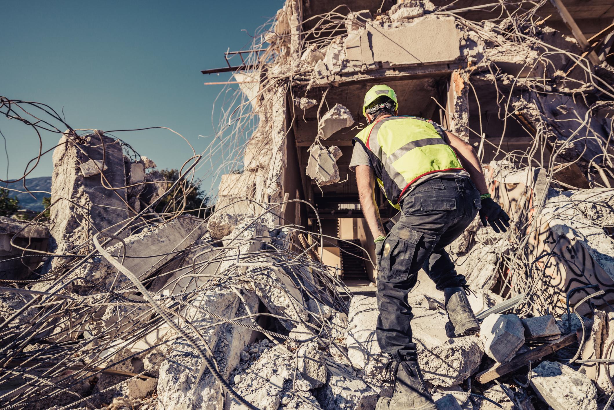 A government employee surveys a disaster area following some sort of natural disaster.
