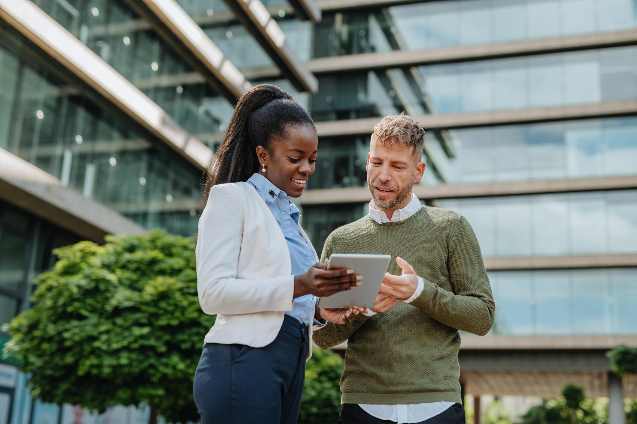 Man and woman using tablet to view city engagement software