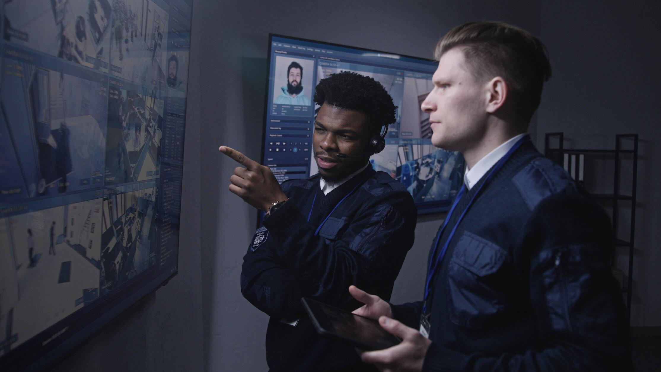 Two officers looking at security footage