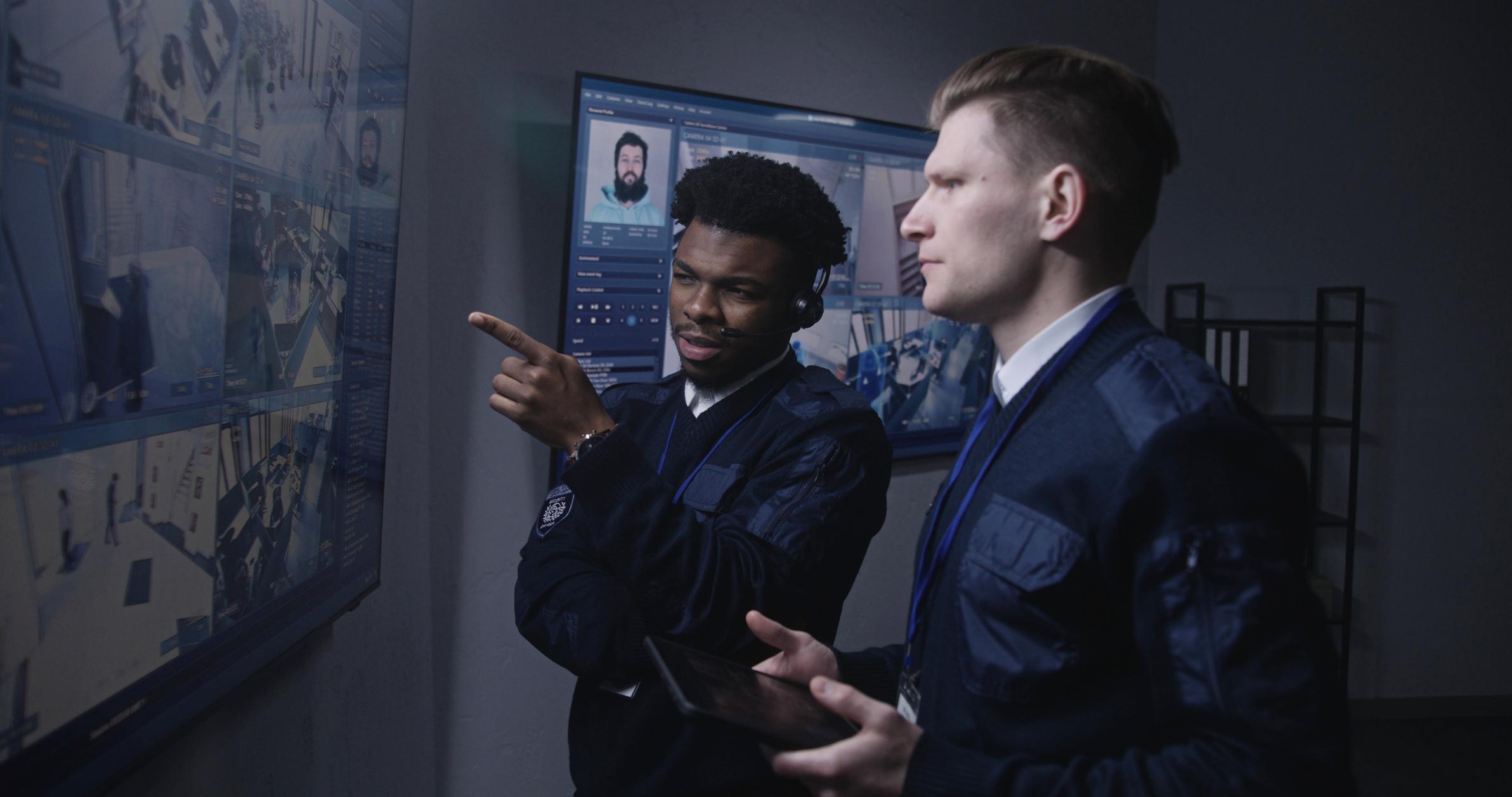 Two officers looking at security footage