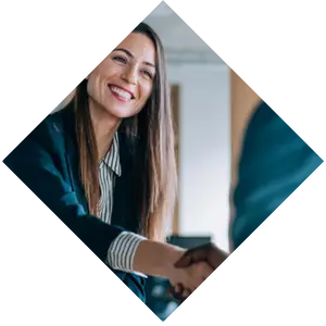 Smiling business professional woman who is shaking hands with someone
