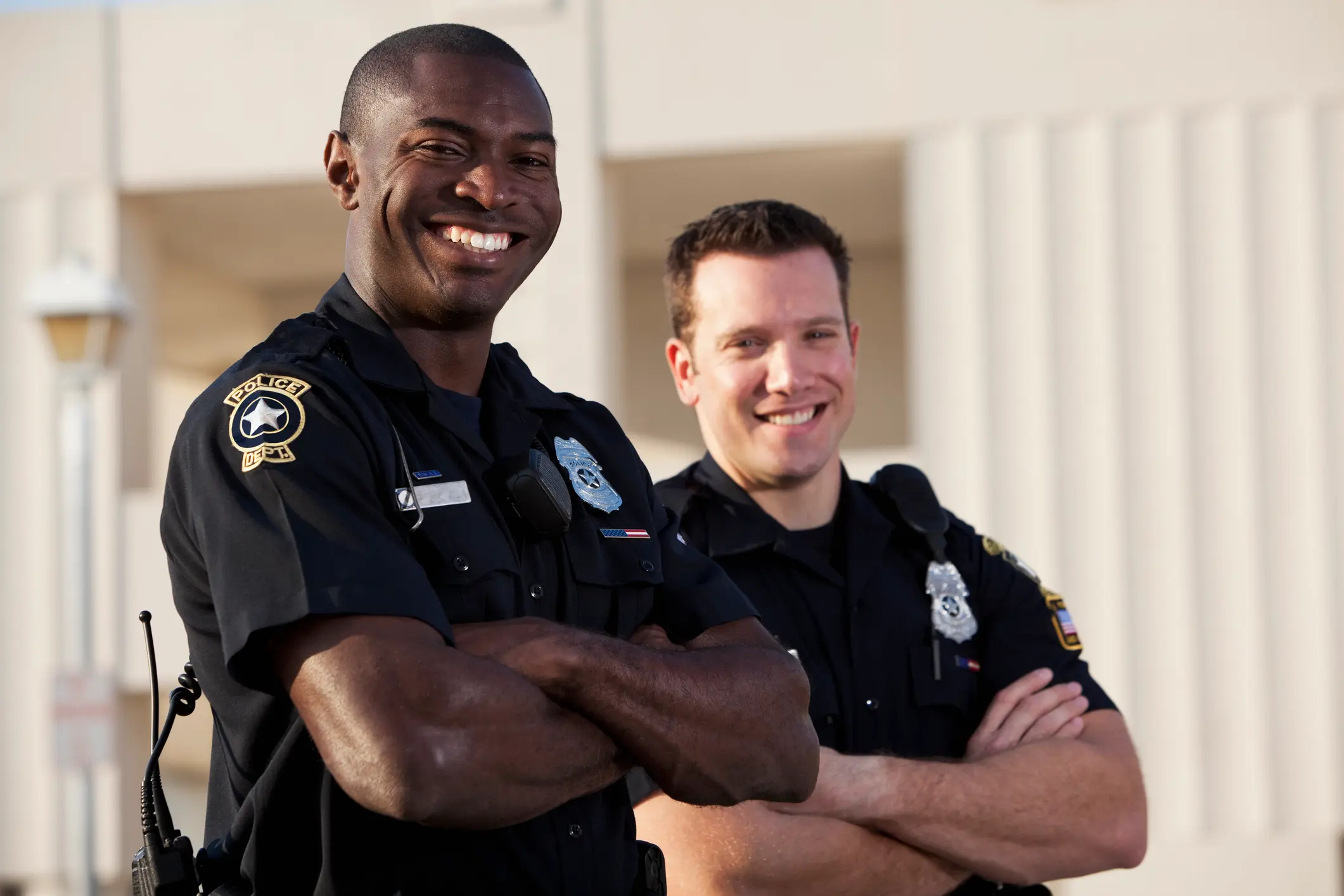 Multi-ethnic police officers (20s). Focus on African American man.